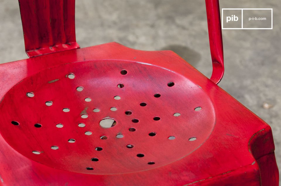La chaise dispose d'une belle finition rouge patinée.